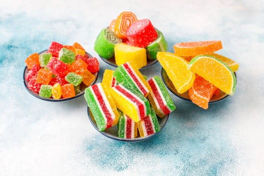 A colorful array of freeze-dried candies in multiple shapes and sizes, displayed against a neutral background.