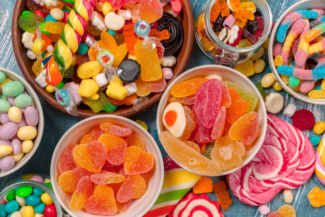 Brightly colored sour candies displayed in various containers.