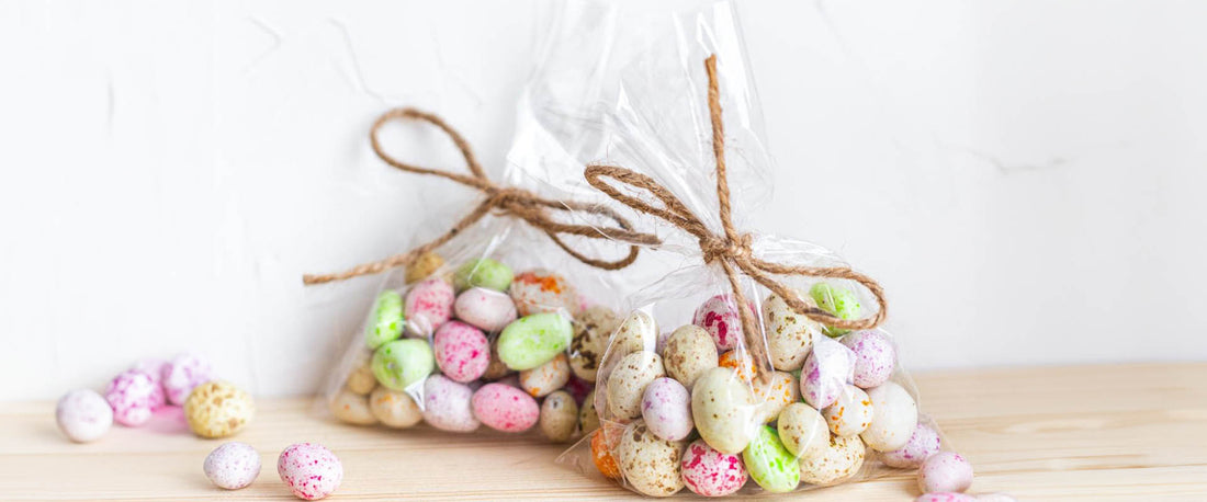 Wrapped bags of candy against a neutral background.