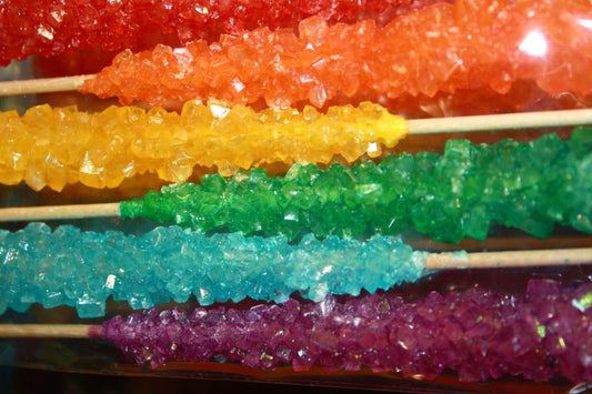 Rainbow-colored rock candy sticks.