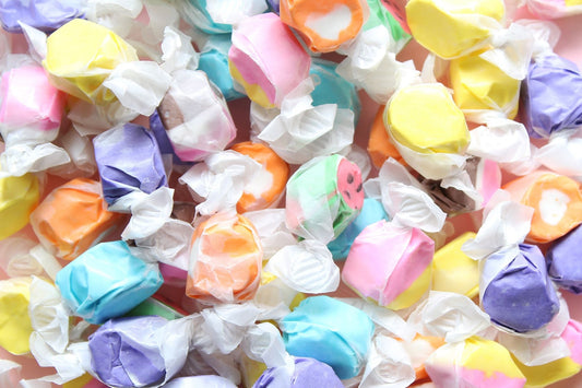 A pile of salt water taffy of all different types and flavors.