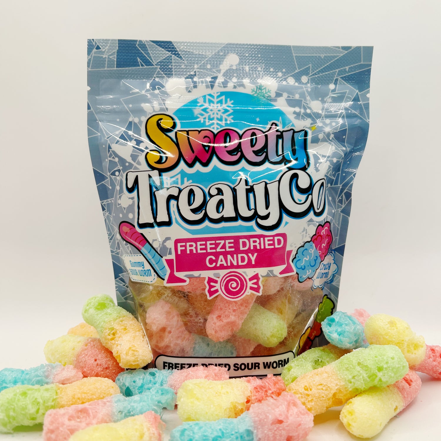 A colorful package of SweetyTreatyCo freeze-dried candy with various multicolored sour worm candy.
